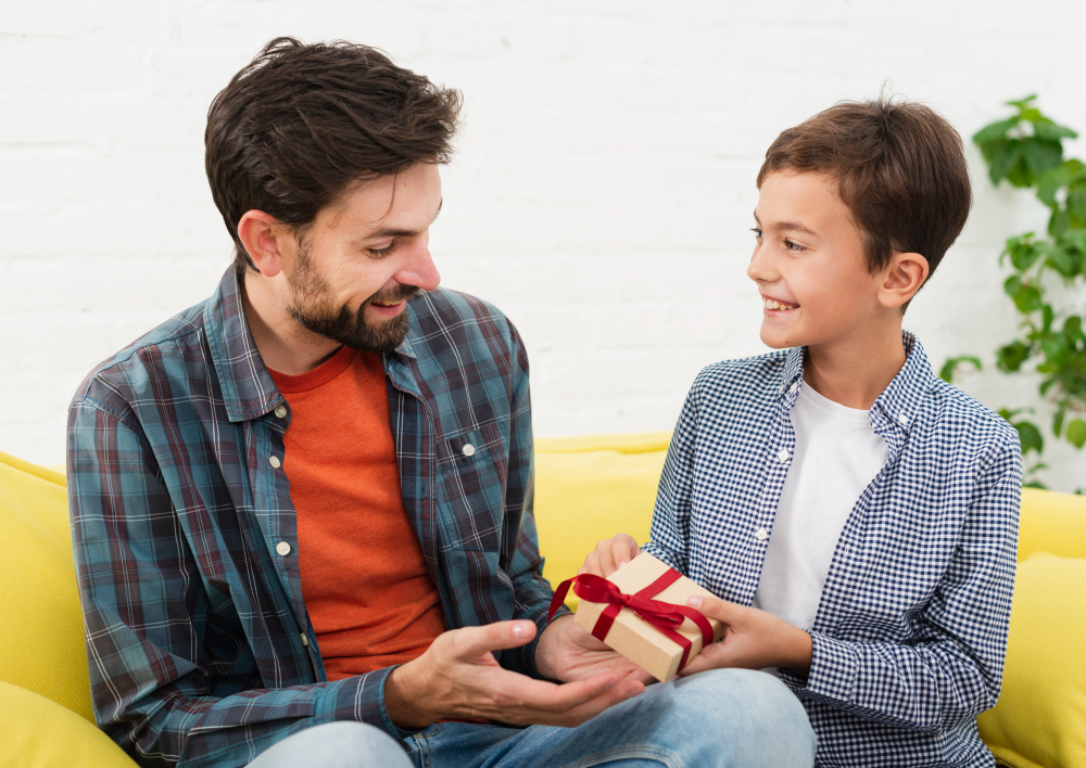 Free photo smiling son offers a gift to his father